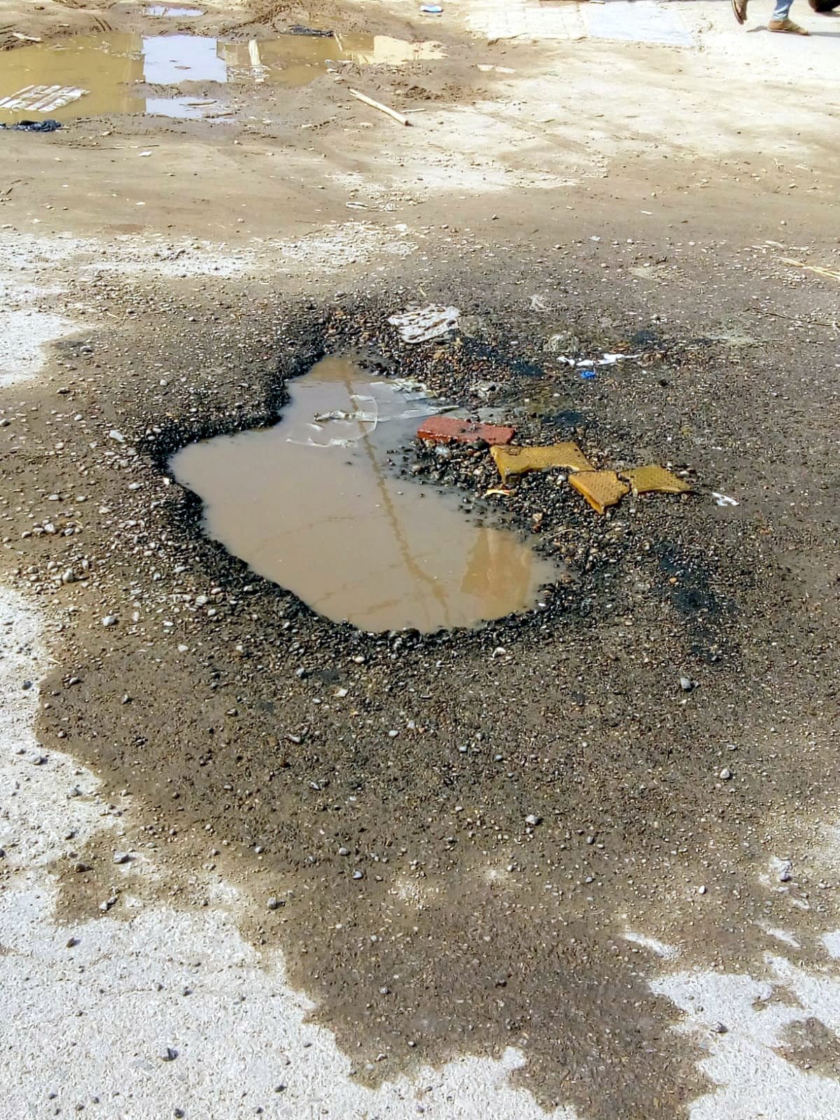 Potholes in the road due to water leakage, fear of accident