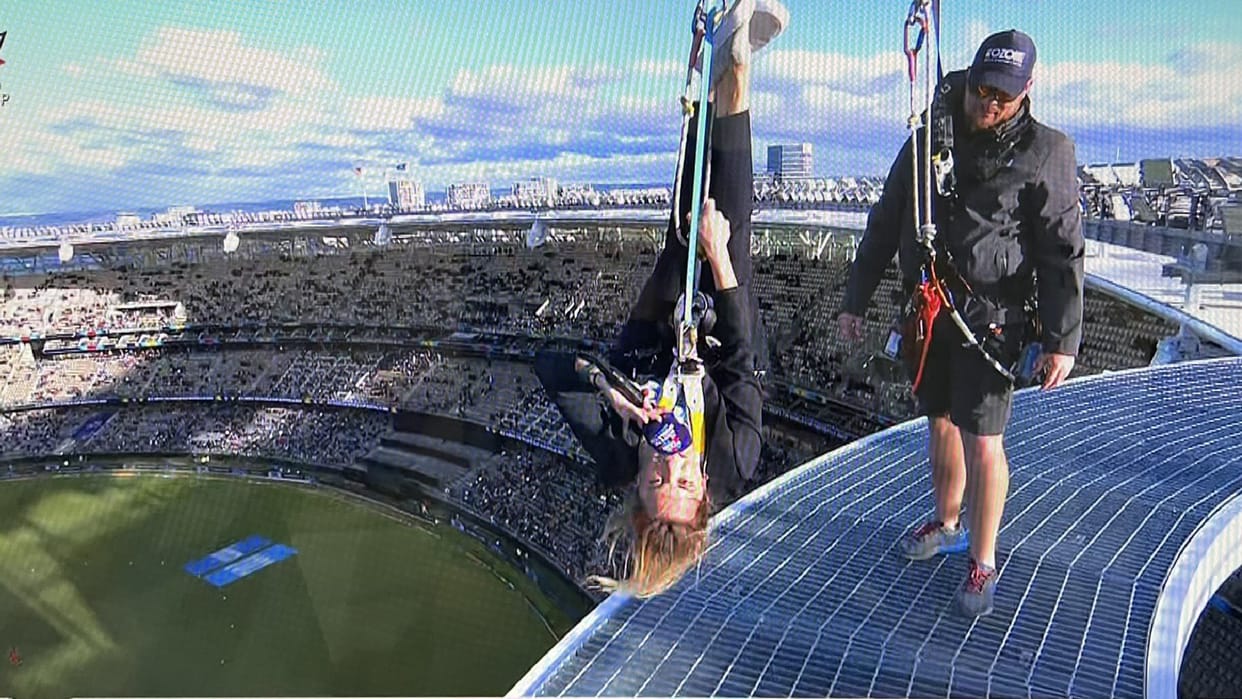 Natalie Germanos commentary from roof of Perth Stadium Hanging with rope