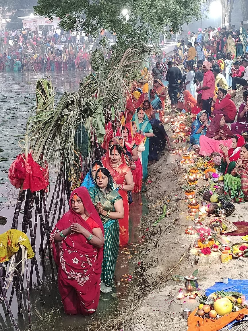 Offering arghya to the rising sun and wishing for happiness and prosperity