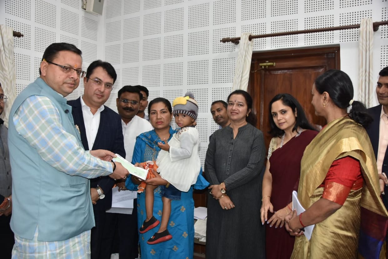 Uttarakhand CM Dhami hands over check of Rs 50 lakhs to Deepmala wife of constable Late Pradeep Kumar