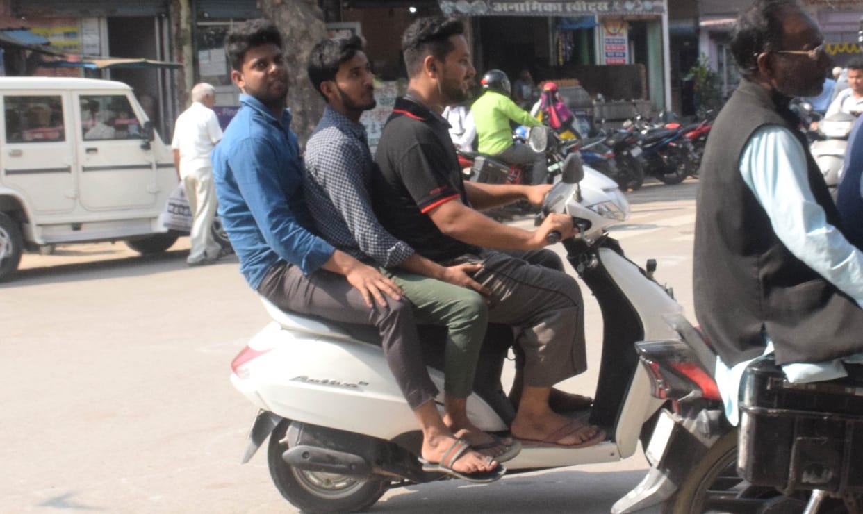three riders without helmet