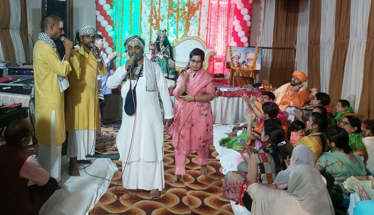 Devotees dance on the hymns of Radha-Krishna in Bhajan Sandhya