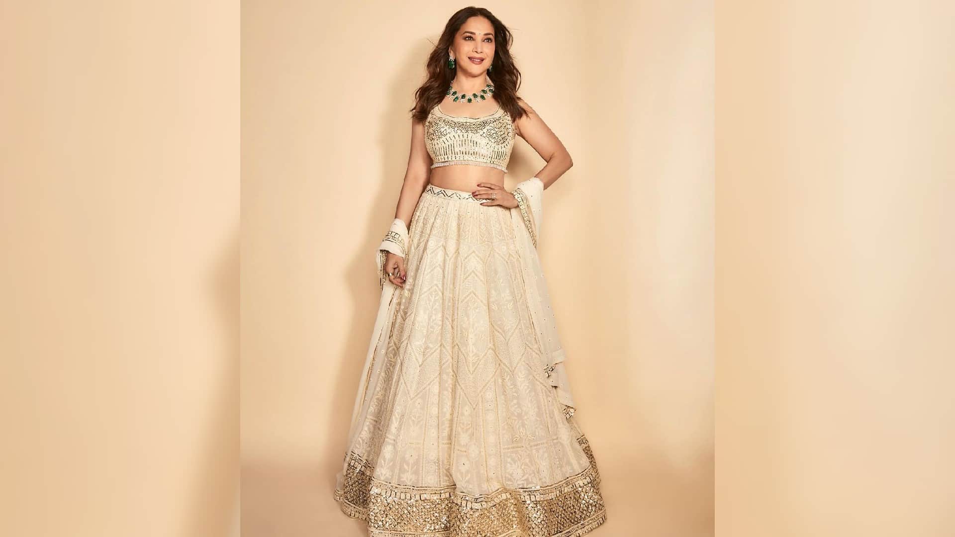 madhuri dixit looks charming in ivory lehenga set with emerald necklace