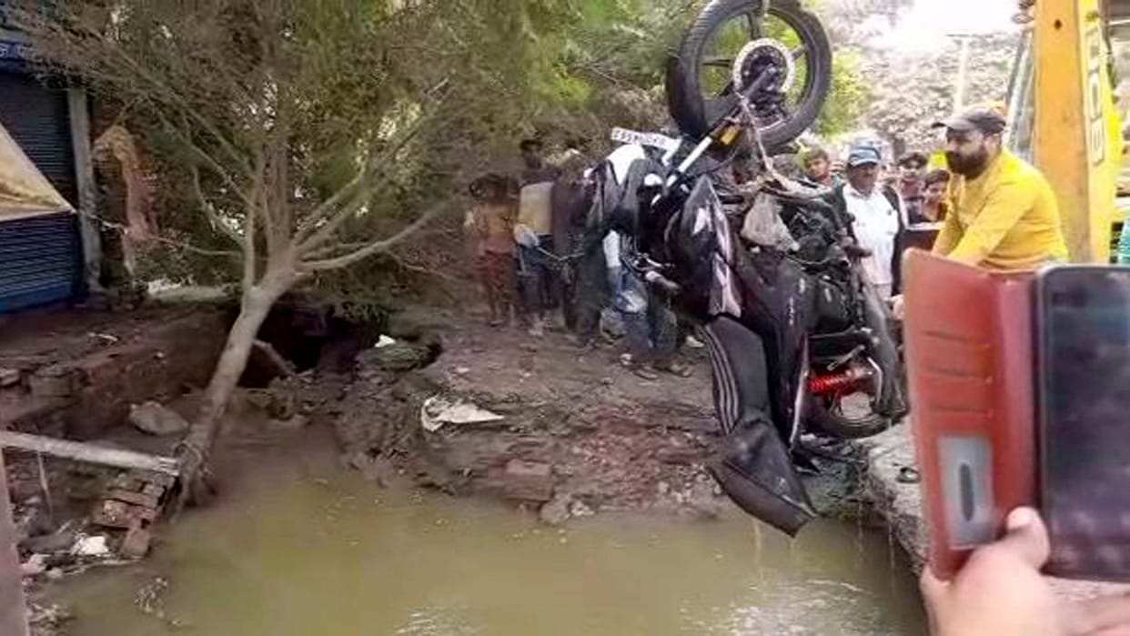 main line of sewerage pumping station torn, two bikes parked on the road