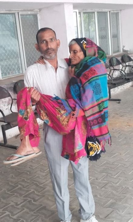 Broken wheelchair, caregiver taking care of disabled in lap