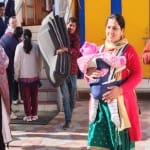 नवजात शिशु को गोद में उठाकर वोट डालने पहुंची महिला।