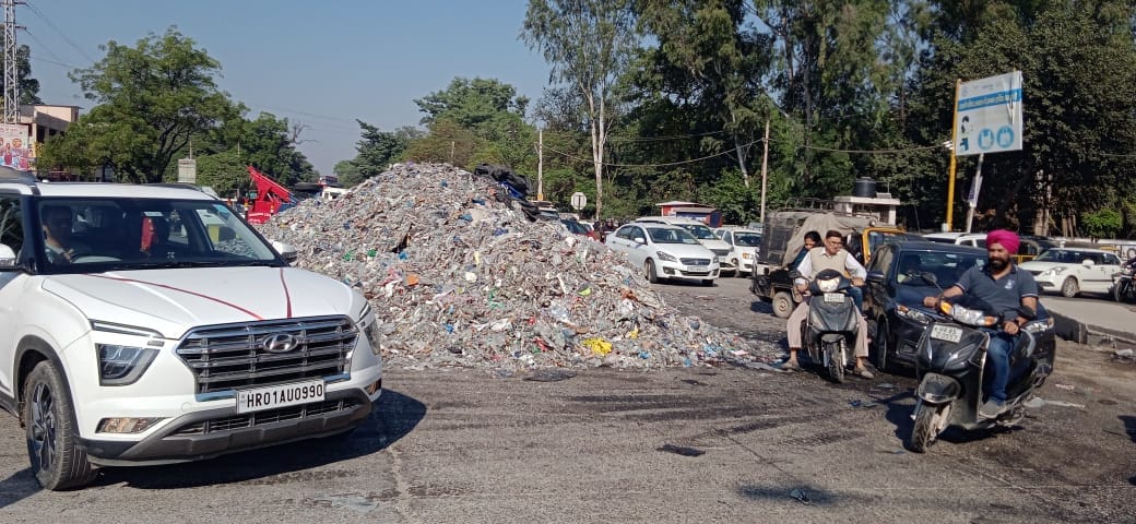 Garbage truck going for recycling overturns on roundabout, pile of accumulated dirt