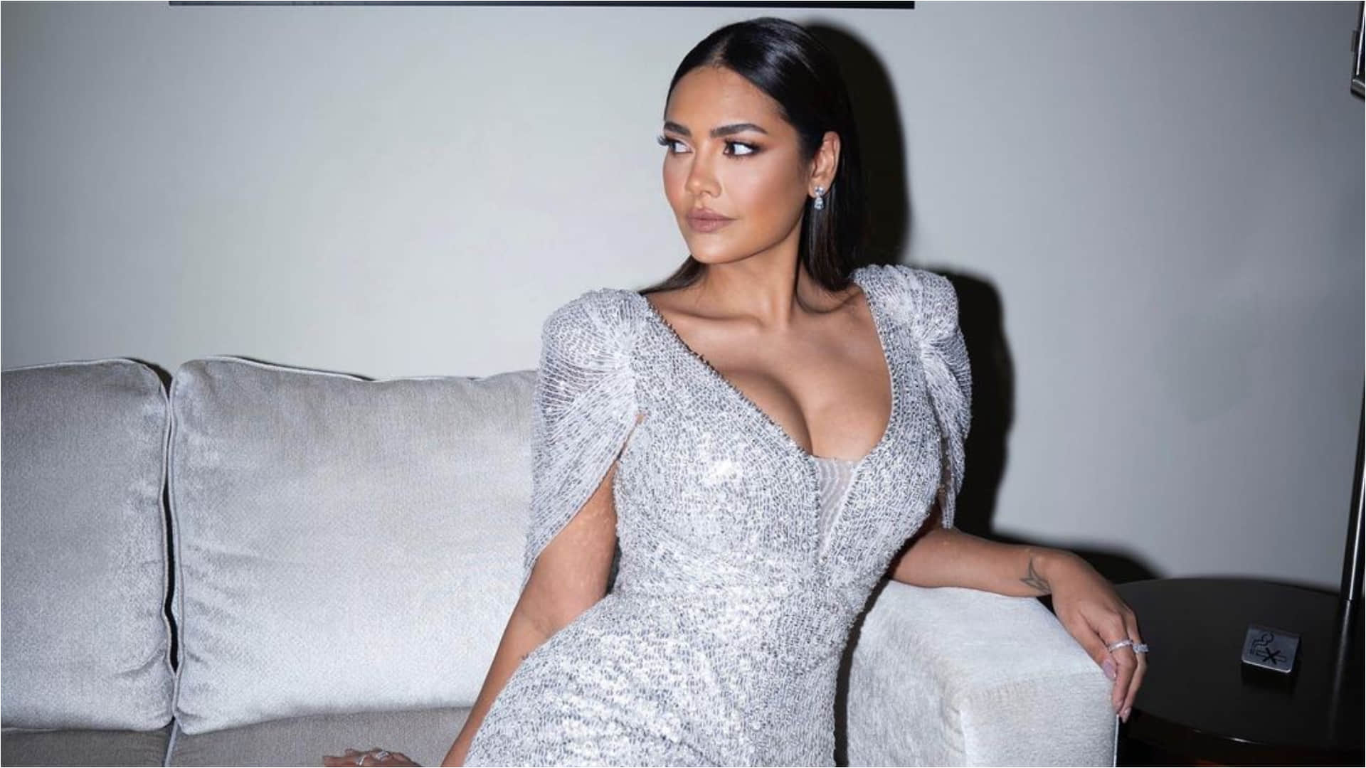 esha gupta gorgeously poses on couch in silver gown bold and hot photoshoot