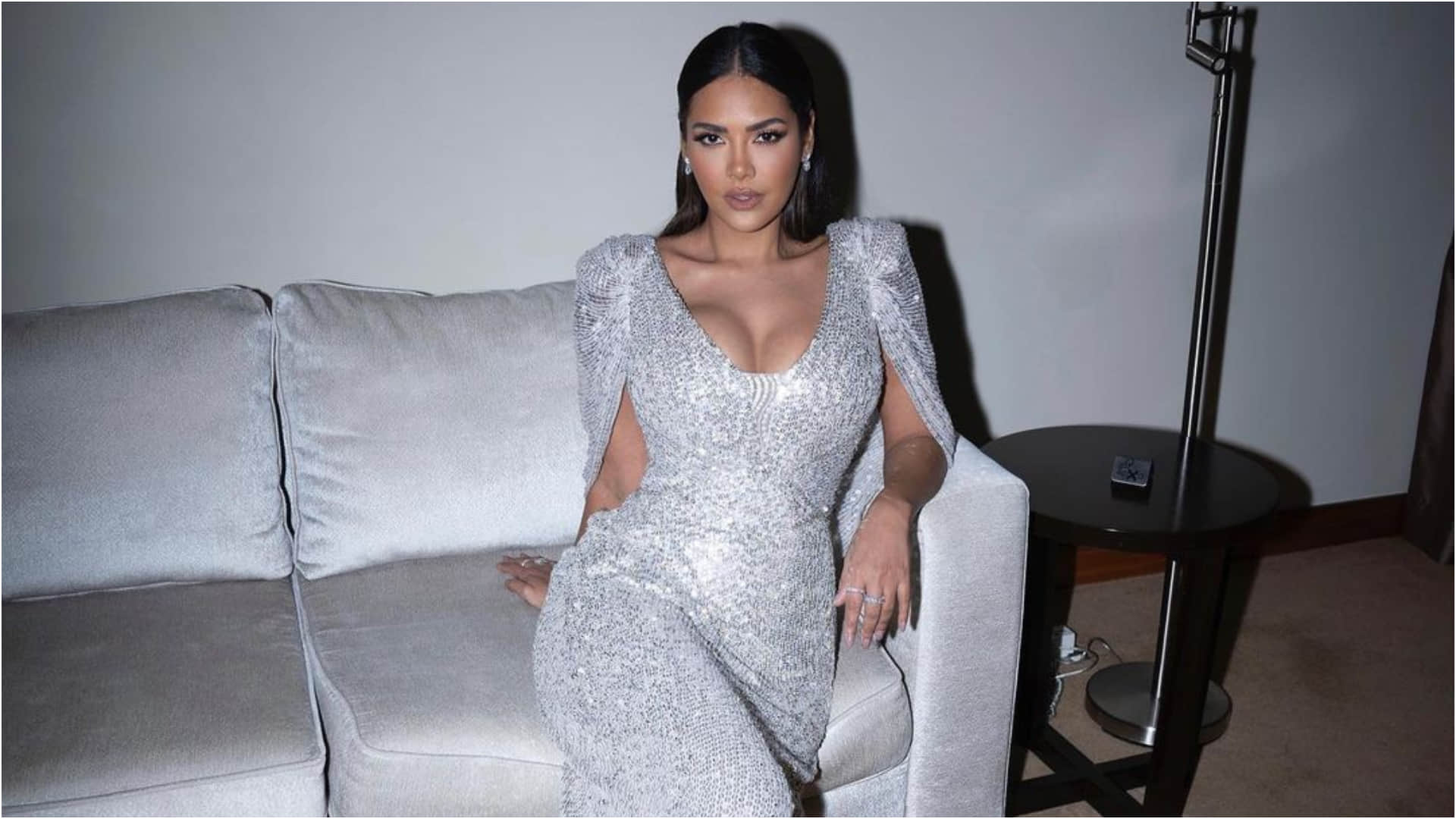 esha gupta gorgeously poses on couch in silver gown bold and hot photoshoot
