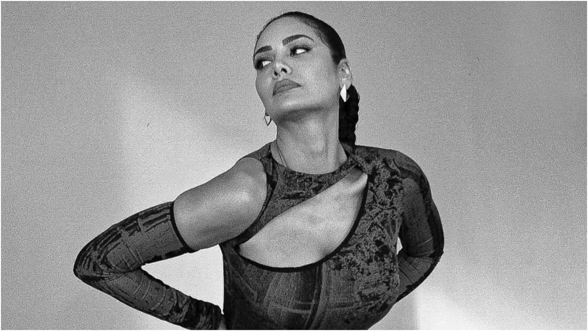 esha gupta gorgeously poses on couch in silver gown bold and hot photoshoot