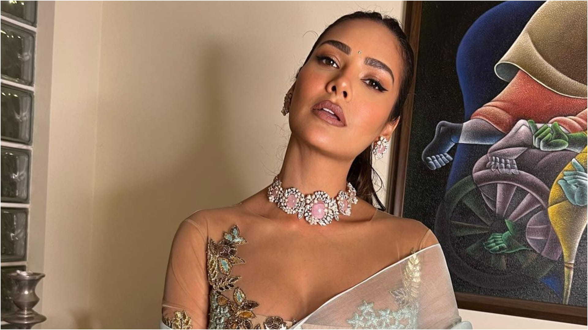 esha gupta gorgeously poses on couch in silver gown bold and hot photoshoot