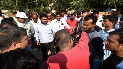 Ruckus on sixlane road project, women lying in front of bulldozer
