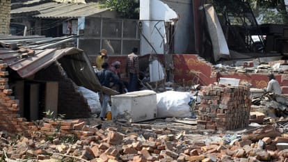 Ruckus on sixlane road project, women lying in front of bulldozer