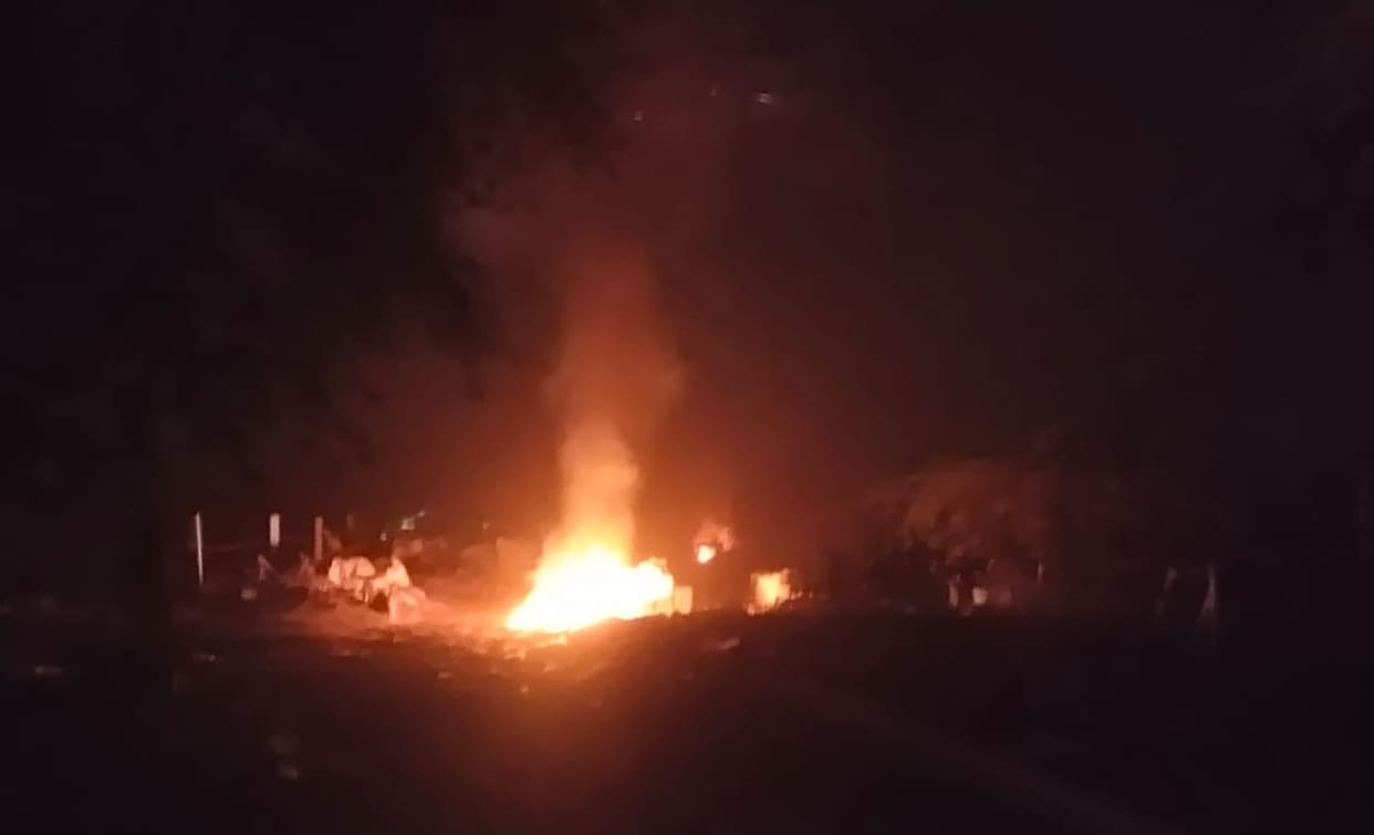 Officers sleeping peacefully, garbage being burnt in the industrial area at night
