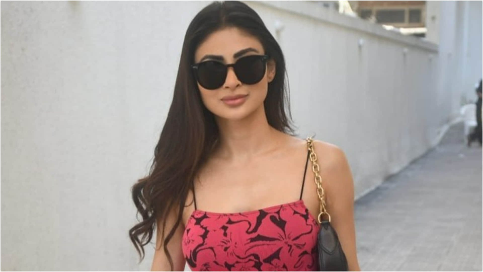mouni roy adjust her extremely tight dress in front of camera wearing pink floral dress