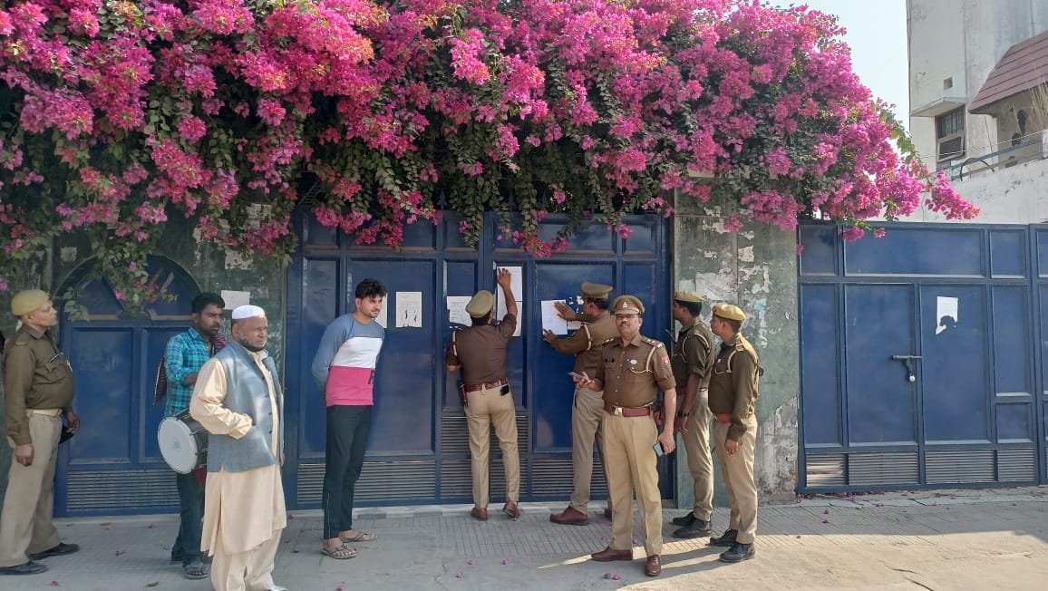 Attachment notice pasted at Haji Iqbal's residence