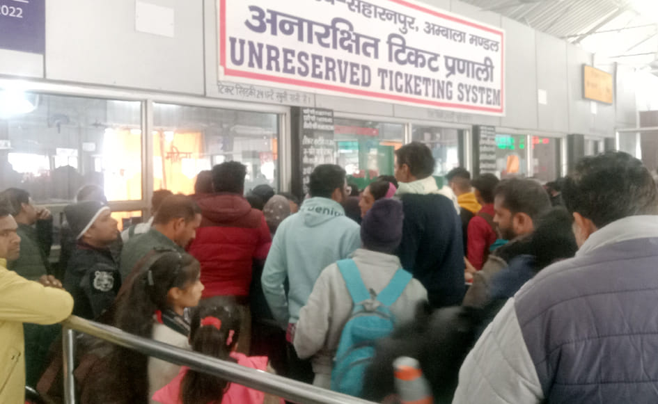 Crowd at unreserved ticket counters, only three out of seven open
