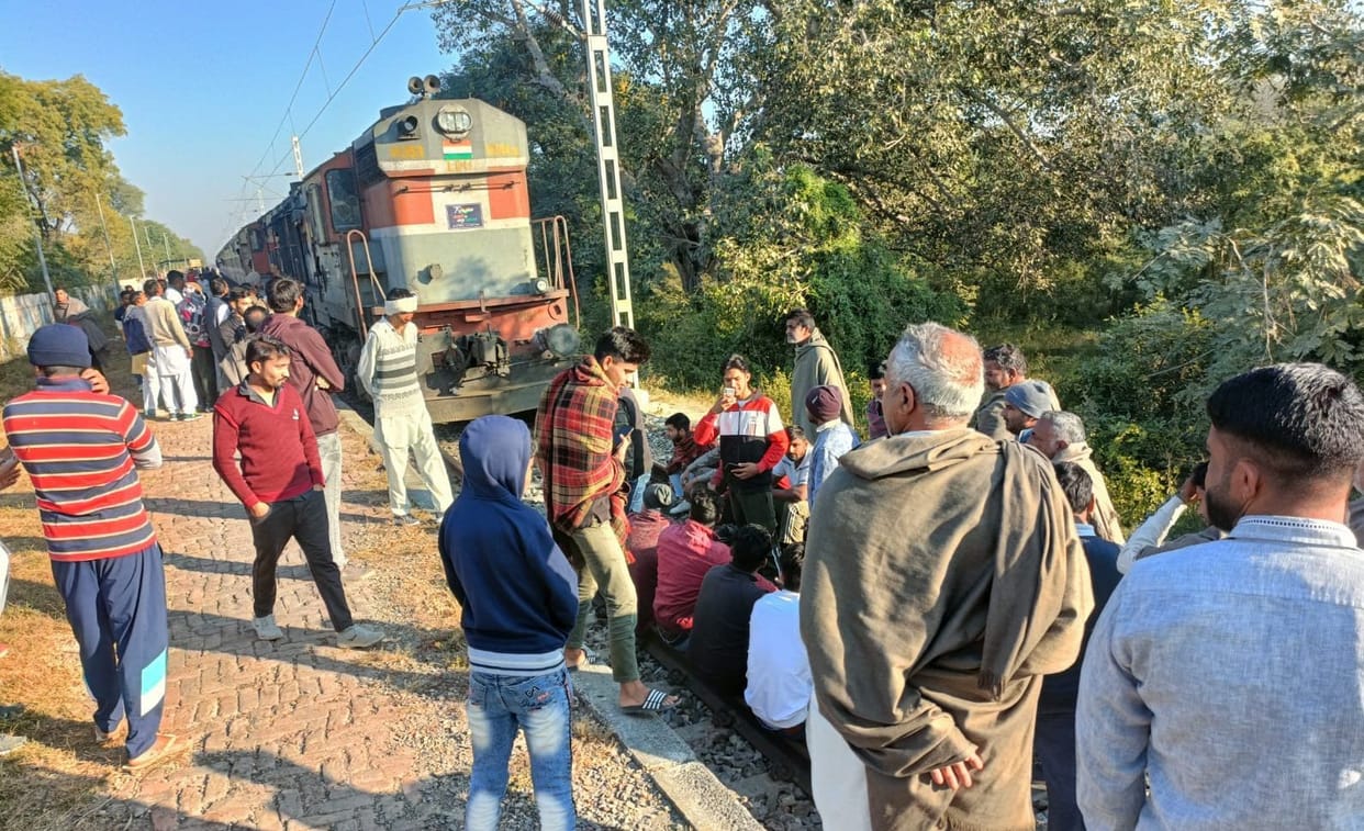 People from four villages sit on railway tracks and protest