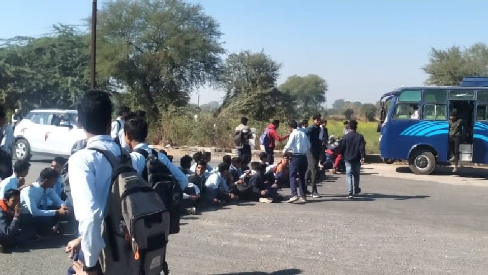 Students block the highway demanding removal of encroachment in the school