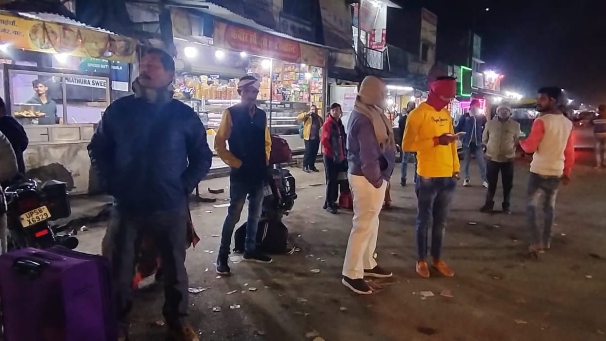 Buses leave from the overbridge, passengers stand below