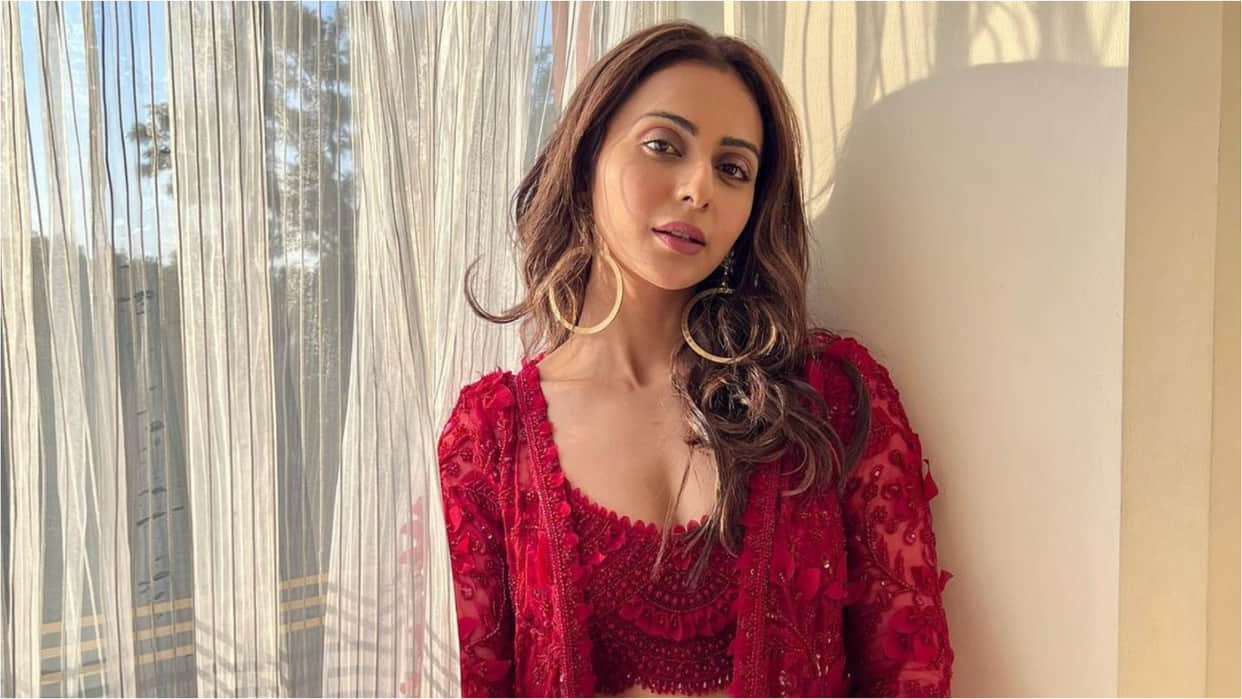rakul preet singh poses in sunkissed light at wedding wearing peach printed lehenga