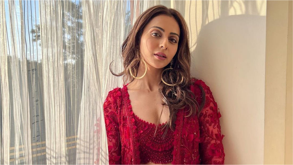 rakul preet singh poses in sunkissed light at wedding wearing peach printed lehenga