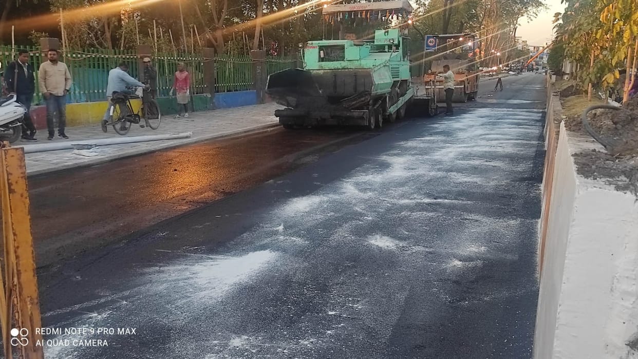Asphalt put on cement road, extravagance in the name of migrant conference