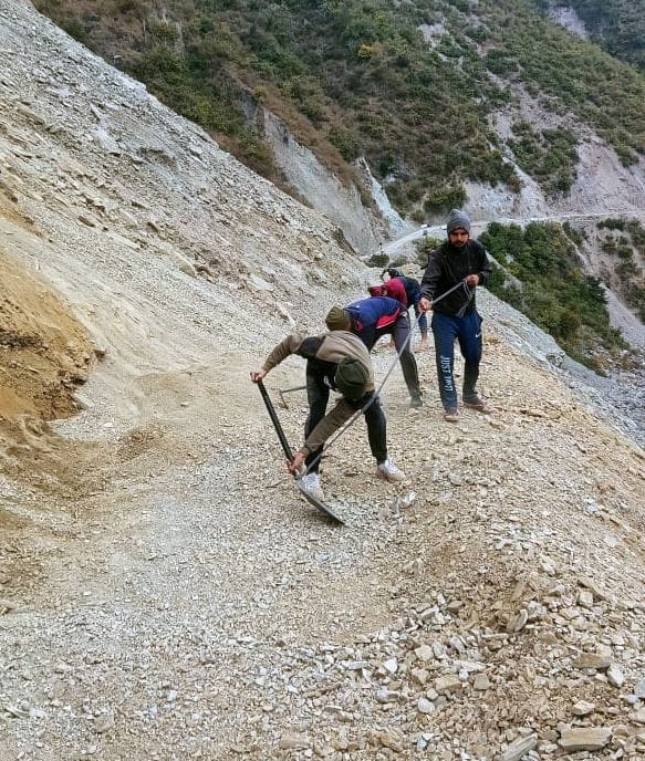 Villagers engaged in opening the road