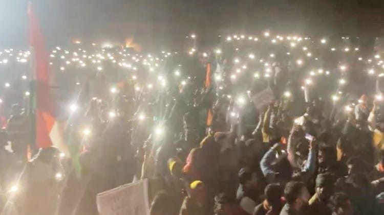 रात में टॉर्च जलाकर नारेबाजी करते कार्यकर्ता।