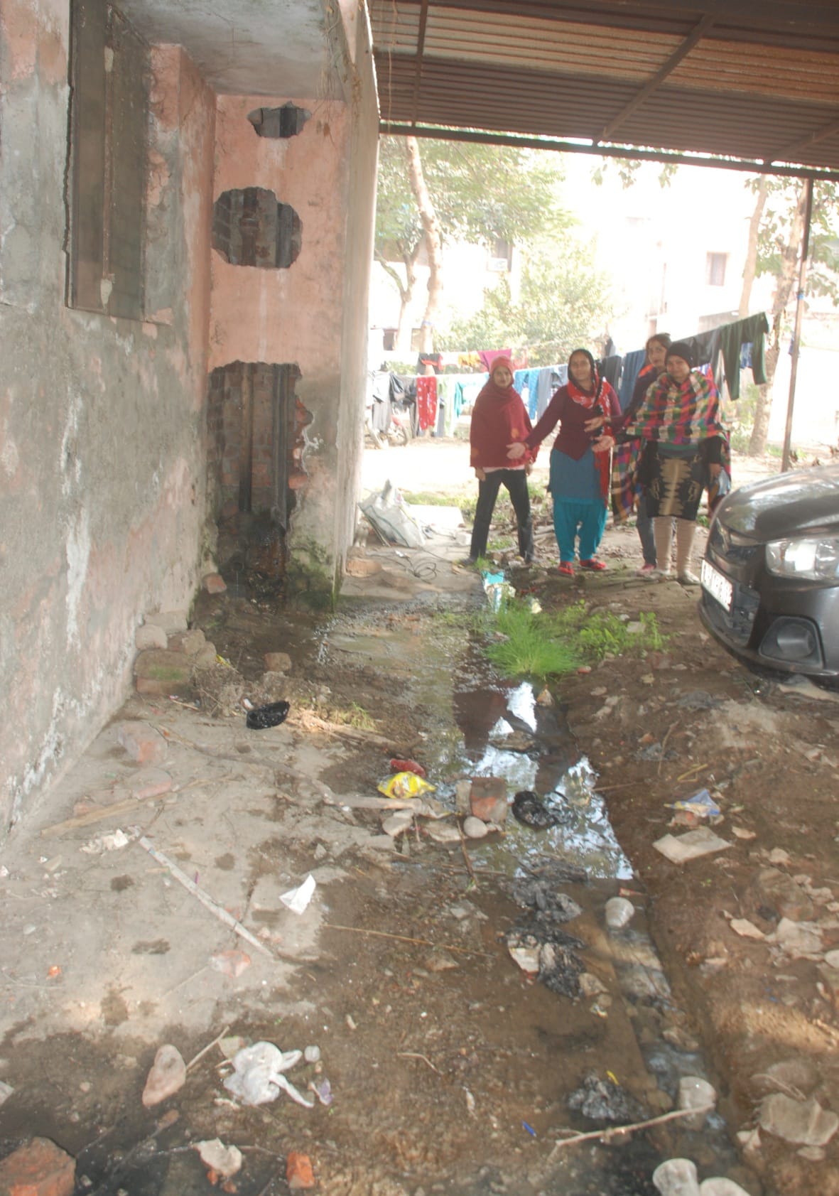 Broken road in Officers Colony, a trap of filth