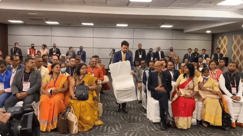 Anurag Thakur sitting among NRIs by lifting the chair himself