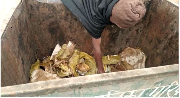 person started eating food thrown in the garbage People passing through the road remained heartless