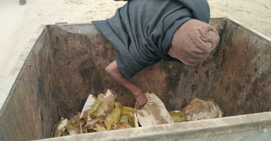 person started eating food thrown in the garbage People passing through the road remained heartless