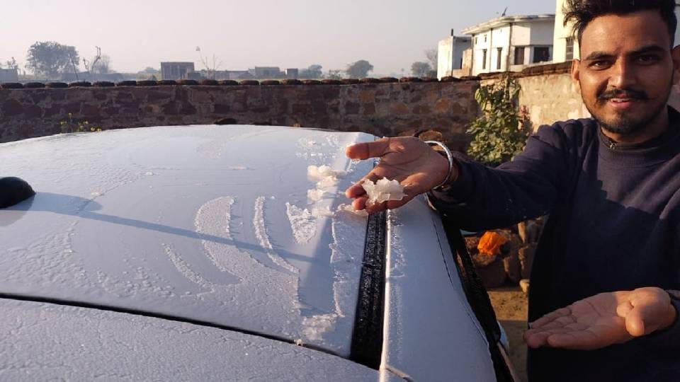 Layer of ice frozen on roofs of cars lying and frost on fields cold like Shimla in Bharatpur