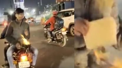 बाइक पर सिगड़ी बांध कर हाथ तापता युवक