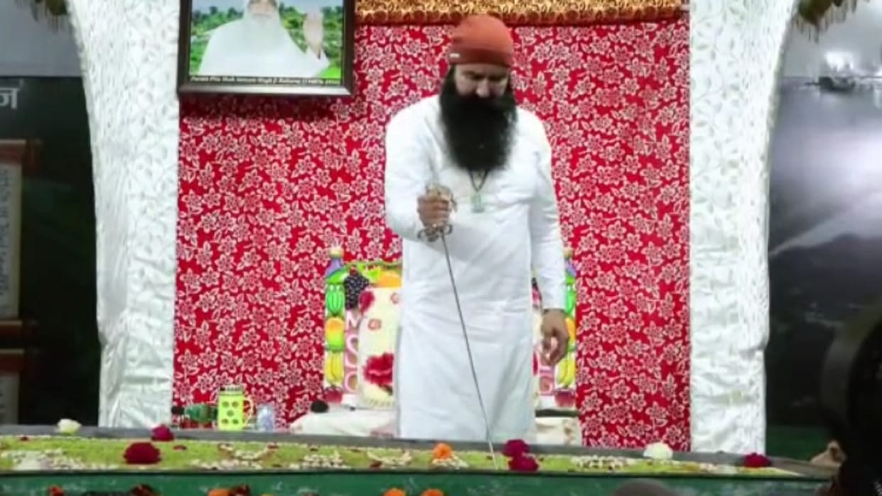 Dera Sacha Sauda chief Gurmeet Ram Rahim spotted cutting a cake with a sword during his ongoing 40-day parole