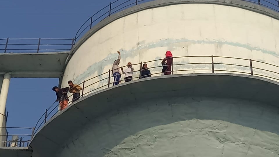 family members of the accused of murder case climbed on the 100 feet high water tank