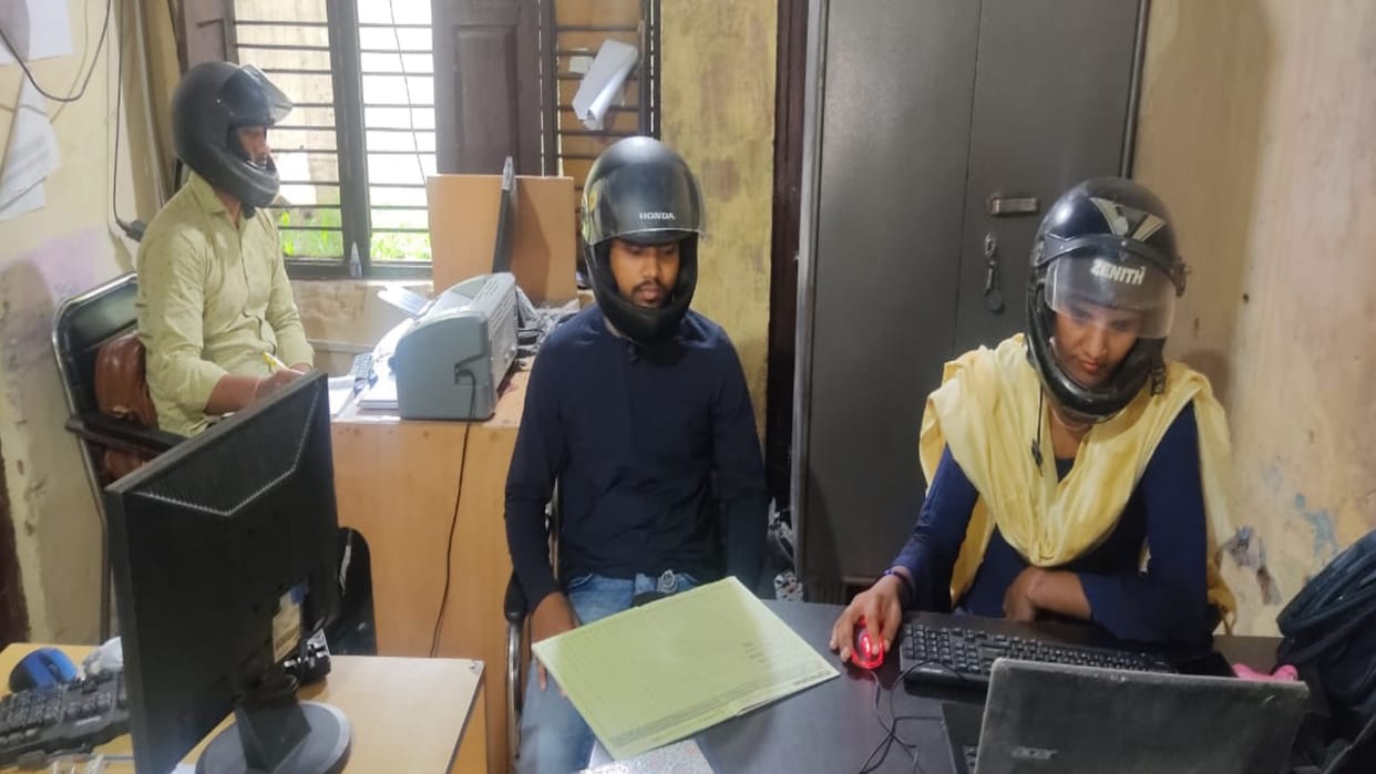 Employees working in office wearing helmet due to fear of death in Baghpat