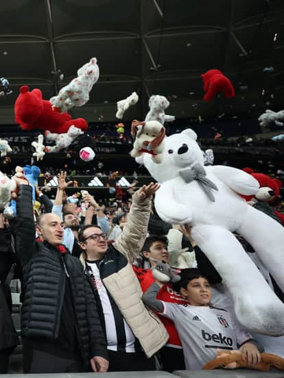 Besiktas, fans, throw, toys, during, football match, on pitch, for children, affected, by, Turkey ea