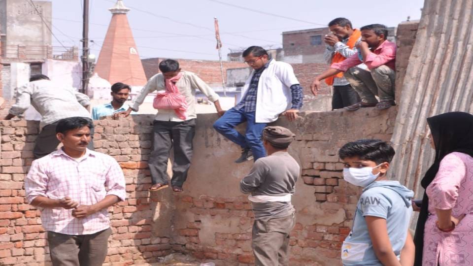 Doctors and patients climb over wall to reach hospital at TB department of SN Medical College in Agra