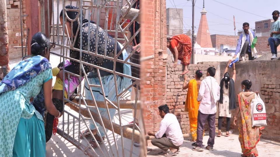 Doctors and patients climb over wall to reach hospital at TB department of SN Medical College in Agra