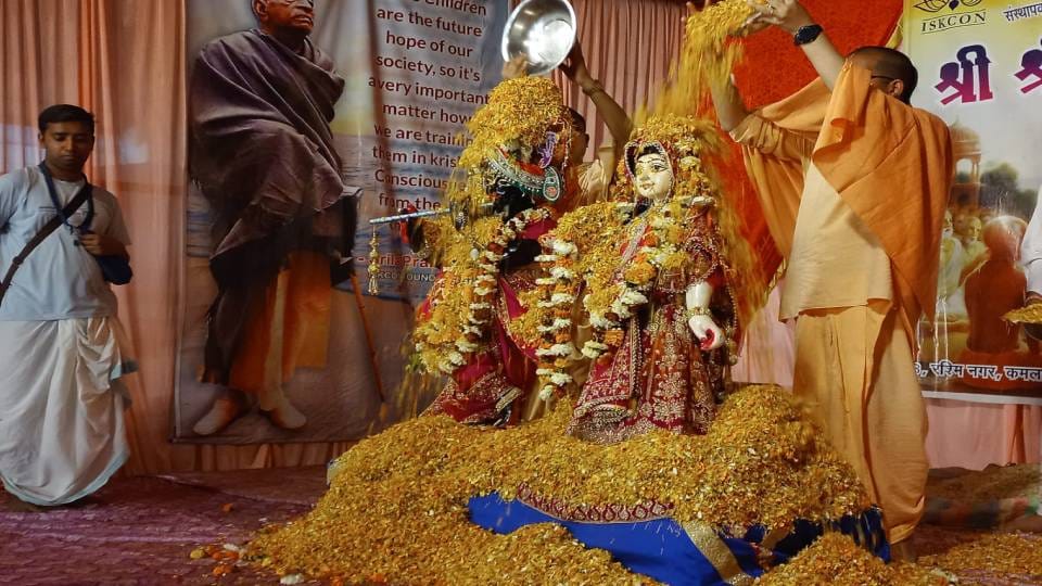 Devotees play Holi of flowers with Radha-Krishna at Shri Jagannath Temple in Agra