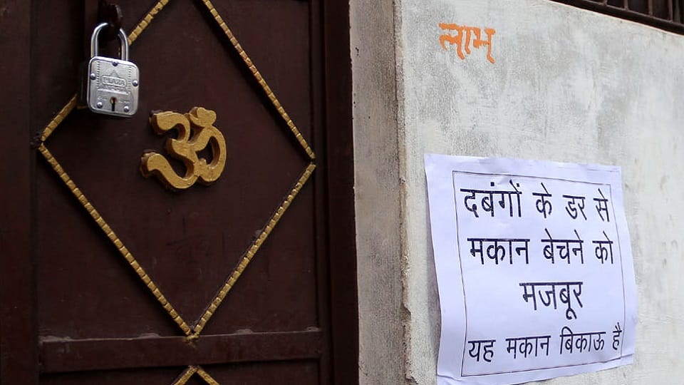 Posters on houses in panic written forced to sell houses due to fear of bullies
