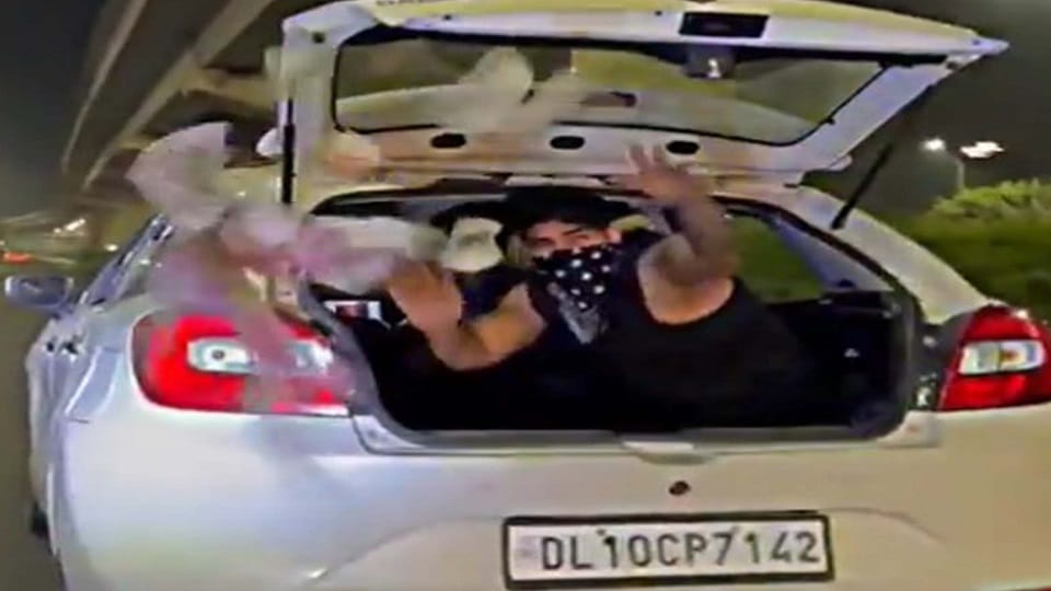 video viral a man throwing currency notes from his running car in Gurugram