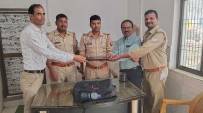 यात्री को लैपटॉप सौंपते पुलिसकर्मी