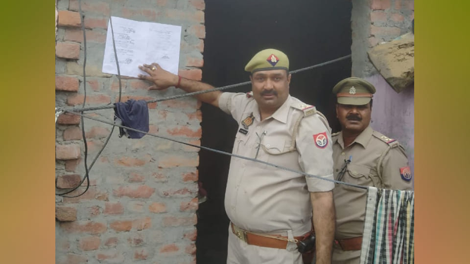 police have pasted attachment notice at absconding rape accused house In Etah