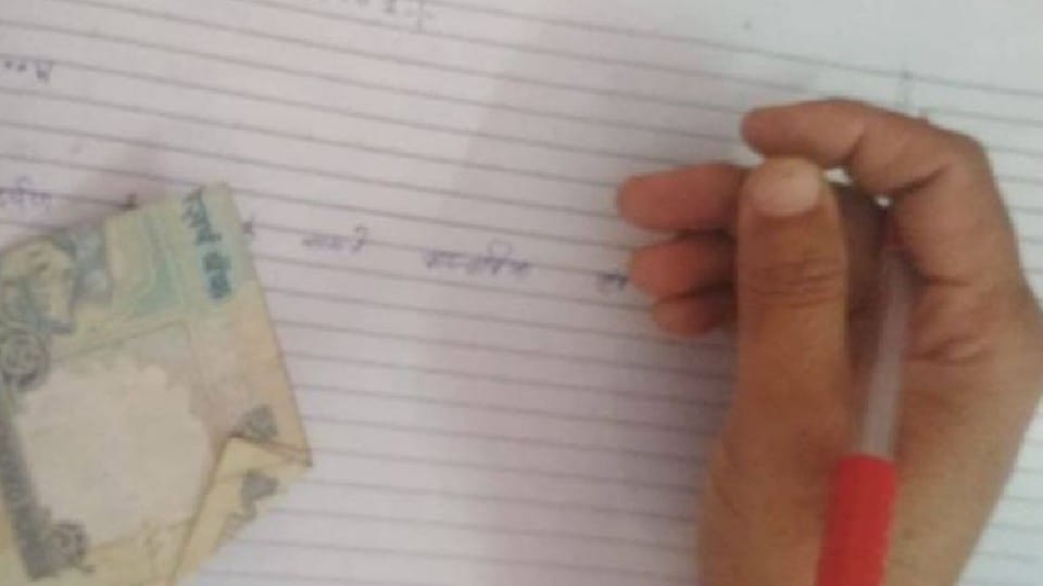 Up Board Exam Student Attached Currency With Answer Sheets for Passing Exam