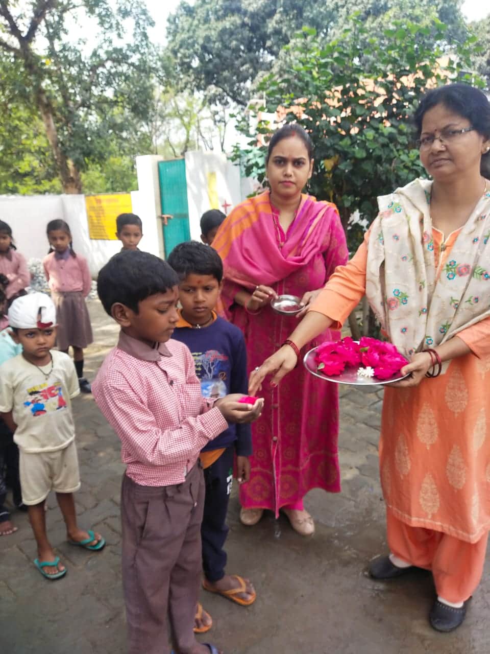 Somewhere children were welcomed by giving sandalwood vaccine and somewhere flowers, children were happy