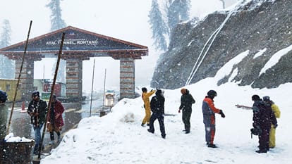 बर्फ के बीच मस्ती करते सैलानी।