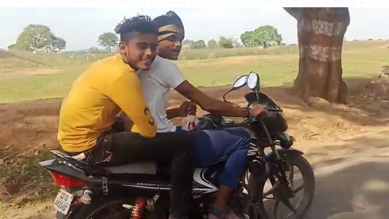Chhattisgarh Young men drinking alcohol riding bike on streets in GPM